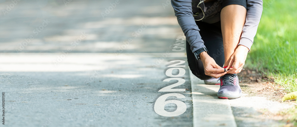 Naklejka premium The start into the new year 2026. Start up of runner woman running on nature race track go to Goal of Success. People running as part of Number 2025. Holiday sport and health care Concept