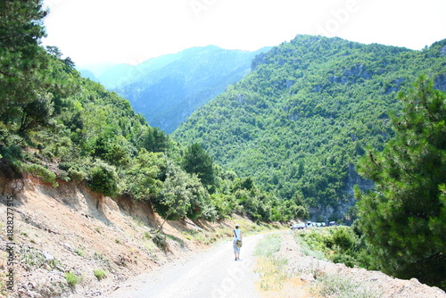 Gravel mountain road with lone hiker, Khalkidiki, Greece, July, 2008