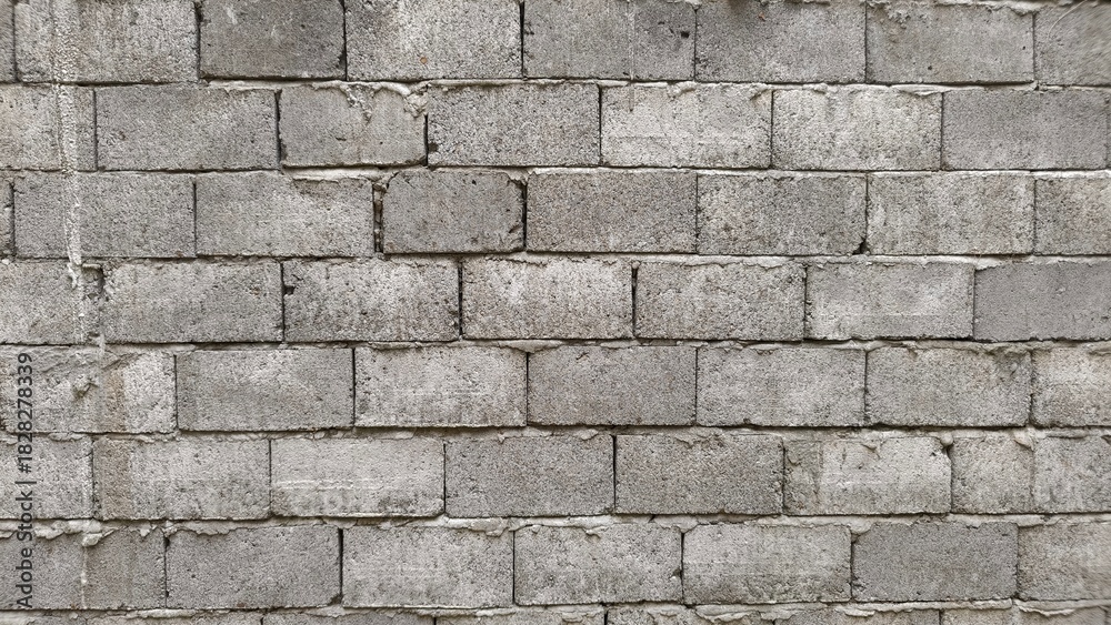 Fototapeta premium Gray brick wall texture perfect for backgrounds, architecture design, industrial themes, and creative visual projects.