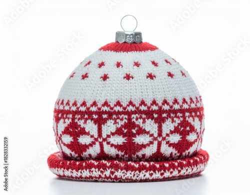 Hand-knitted Christmas ornament resembling a winter hat with traditional Nordic snowflake pattern in red and white