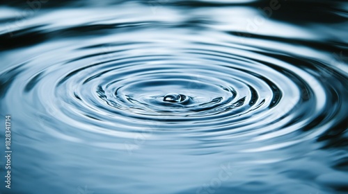shrinkage. Raindrops creating circular ripples on a calm water surface, serene blue tones. ESG reports, sustainability campaigns, designed for environmental awareness campaigns.