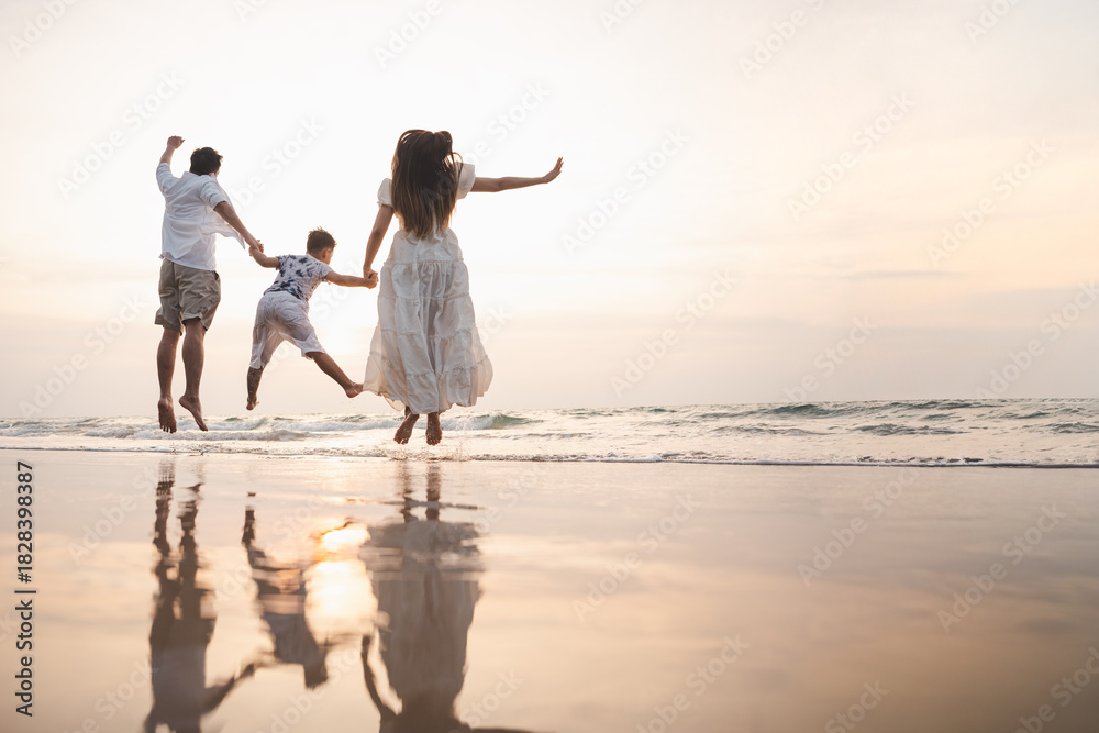 Fototapeta premium family, vacation, beach, happy family, holiday, asian, fun, happy, A happy family jumps together on the beach at sunset, enjoying a joyful and relaxing vacation moment.