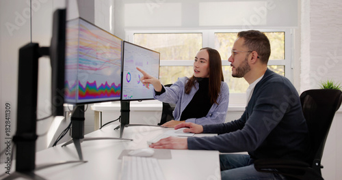 Photography Team Of Analysts Reviewing Business Data
