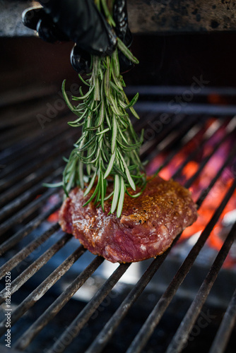 Pepper steak grilled with a sprig of rosemary