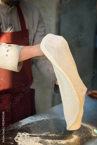 Pizza chef prepares pizza dough