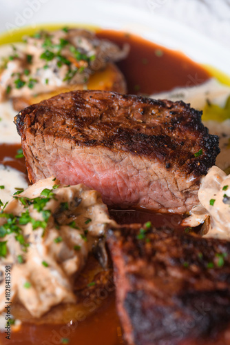 Pepper steak grilled with potatoes, mushroom julienne and three sauces