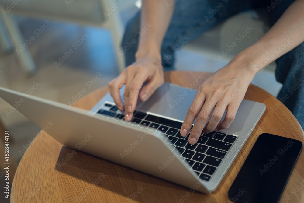 Fotografie Close up of casual business woman hands typing on laptop computer on table, sear