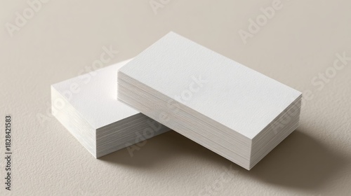 Stacks of blank business cards on a neutral background, ready for customization.