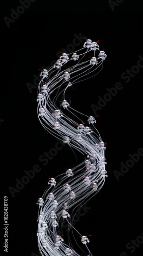 Silver Nanorobot Swarm Converging Upward to Form a Flowing Light Band on Black Background
