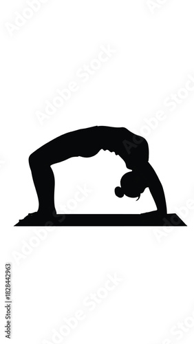 Silhouette of a woman performing a yoga backbend on a mat