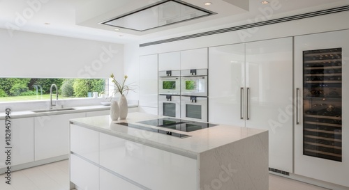 Wallpaper Mural A modern, minimalist kitchen with white cabinets, stainless steel appliances, and a marble island. Torontodigital.ca