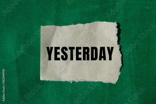 Yesterday message written on ripped torn paper background. Conceptual Yesterday symbol. Copy space.