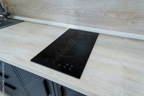 Canvas Print contemporary kitchen design, sleek black induction stove, modern minimalist whit