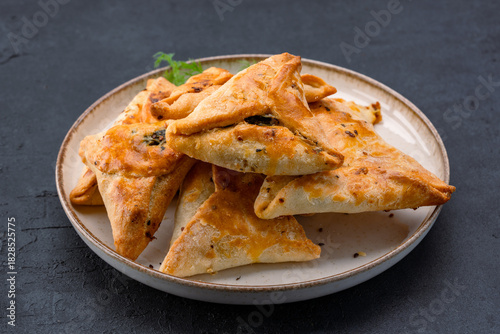 Homemade triangular pastry with spinach and cheese. A traditional Middle Eastern dish.