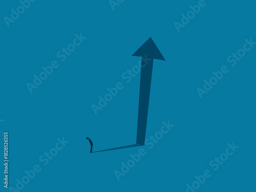 Businessman imagines future growth with arrow shadow