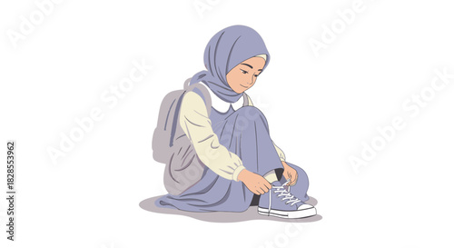 Young Muslim girl sitting on the ground tying her shoelaces and wearing a hijab
