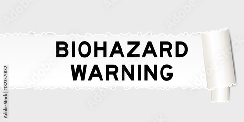 Ripped gray paper background that have word biohazard warning under torn part