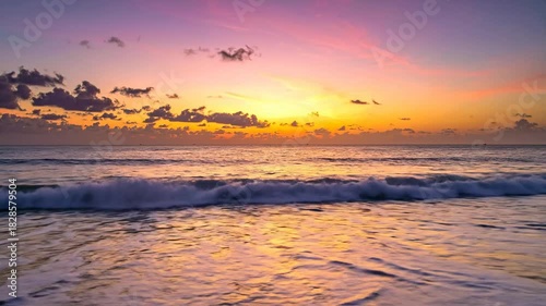 Dramatic Ocean Sunset With Vibrant Pink Orange Sky And Gentle Waves Washing Ashore Reflecting Golden Light On Wet Sand