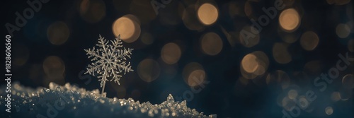 Macro closeup of snowflake crystal on snow with warm golden bokeh lights in winter night