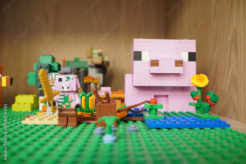 Fototapeta premium Minecraft Lego scene featuring a pig, crops, and a golden sword