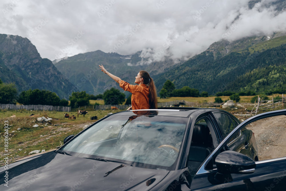 Fototapeta premium woman in car sunroof mountains travel authenticity