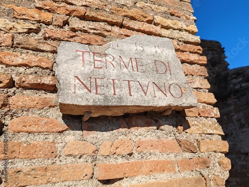 Photography Rome, Italy - November 25, 2025, detail of the marble plaque of the Baths of Neptune, an important public thermal complex in ancient Ostia