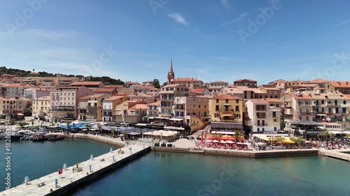 Wallpaper Mural Aerial Drone Pan Shot Over the Bustling Calvi Marina and Waterfront Promenade, Haute-Corse, Corsica, France, on a Sunny Day. Torontodigital.ca