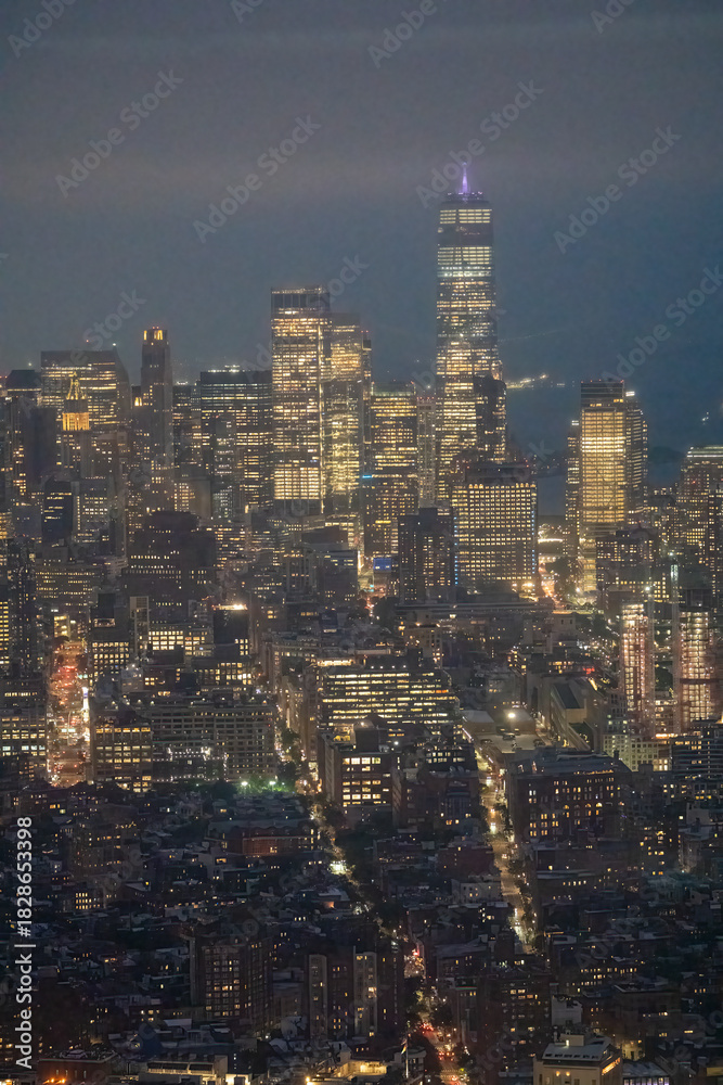 Fototapeta premium Night aerial photography of Manhattan skyline with glowing buildings and bustling streets