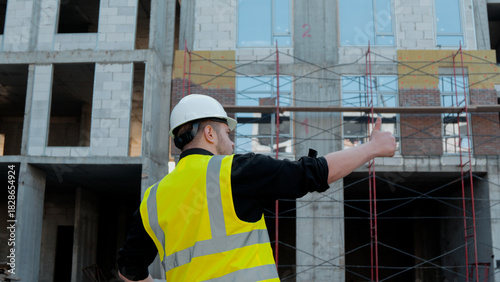 Slika na platnu A construction foreman conducts an inspection at a construction site