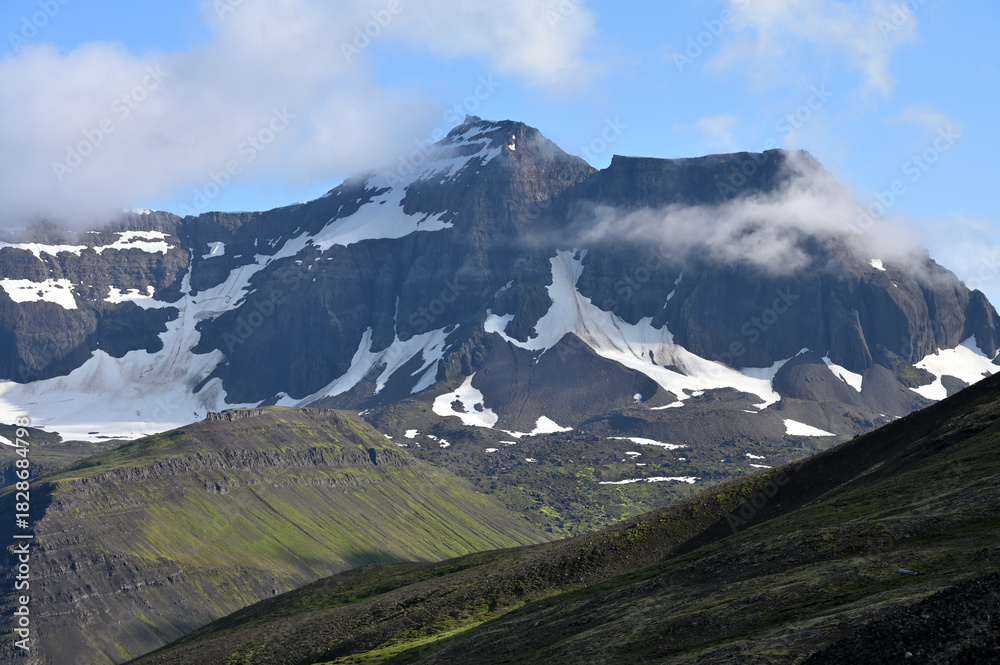 Fototapeta premium Mountain peaks covered with snow, summer in Iceland.