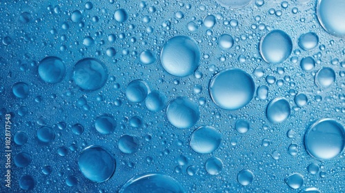 Wallpaper Mural Numerous water droplets rest on a smooth blue surface catching light and creating a tranquil and refreshing effect during daytime. The clear droplets vary in size and shape. Torontodigital.ca