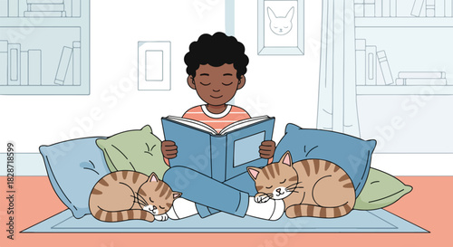 A young boy sits cross-legged reading a book, with two tabby cats sleeping peacefully on either side of him on a blue rug.