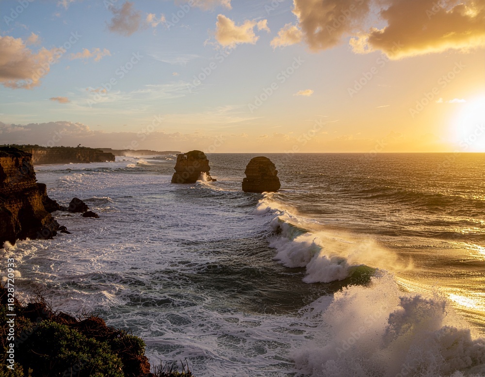 Fototapeta premium Breathtaking coastal landscape with dramatic sea stacks and crashing ocean waves under a brilliant golden sunset sky