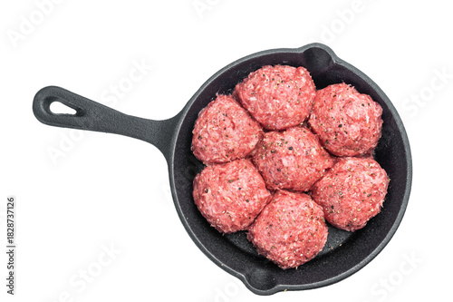 Fresh raw meatballs Polpette in cast iron skillet with seasoning on white background ideal for cooking, protein dishes and food prep themes.