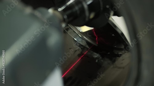 Professional auto mechanic changing and balancing car wheel in a tire fitting workshop
