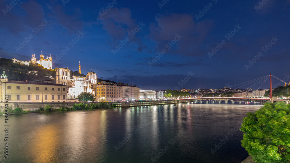 Fototapeta premium Timelapse of Saint John the Baptist Cathedral and Basilica of Notre-Dame de Fourviere in Lyon, from day to night. France
