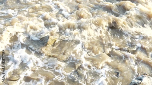 Close up of a foamy sea wave. Top view