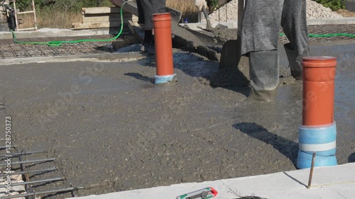 Wallpaper Mural Concrete Pouring, Construction Site, Building Foundation. Workers spread fresh concrete for a new building on a sunny day. Torontodigital.ca