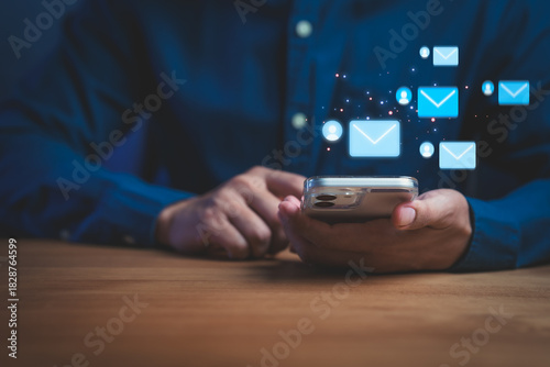 Person using smartphone with email icons symbolizing digital communication, messaging, notifications, online connection, mobile interaction, and modern technology in everyday communication.