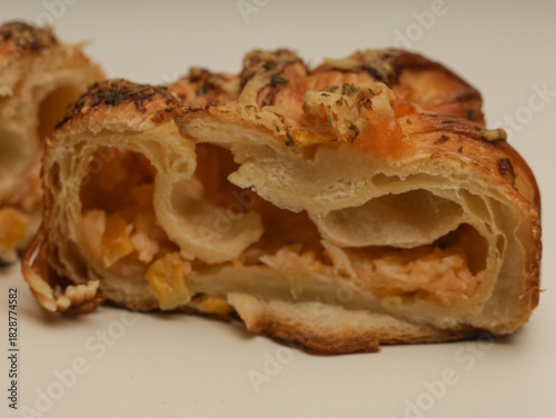 Danish pastry with savory filling on white background