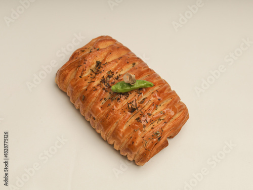 Danish pastry with savory filling on white background
