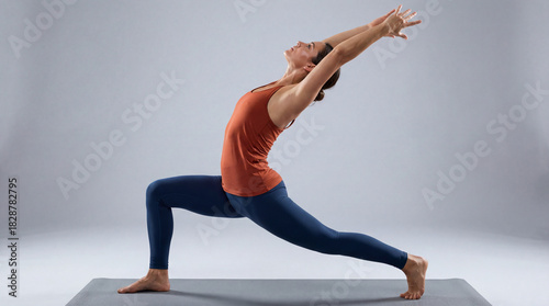 Woman practicing yoga lunge pose in bright minimalist studio