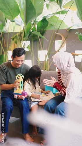 Joyful Asian Family Playing with Colorful Building Blocks Together at Home
