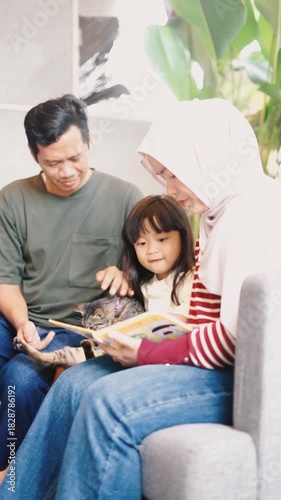 Parents and Child Enjoying Story Time with Kitten