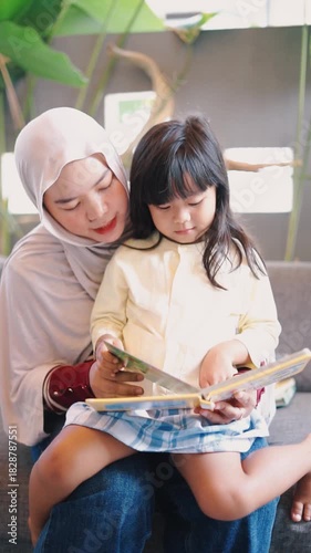 Loving Muslim Mother and Daughter Reading Storybook Together