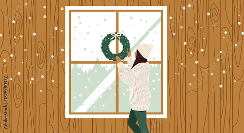Cozy winter scene of a woman decorating a window with a festive wreath indoors surrounded by
