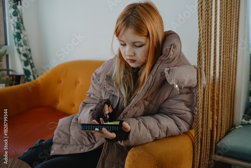 A 12-year-old teenage girl enjoys breakfast in a cozy cafe with fast food. Authentic moment of teen independence, urban lifestyle and casual dining