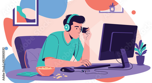 Young man at his computer wearing headphones and holding a credit card for online shopping or paying for a subscription.