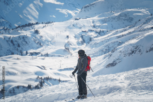 A male skier in the famous and snow secure Ski Arlberg near Lech and Zürs enjoing the sunlit piste below Kriegerhorn, dazzling powder and blue sky radiate alpine freedom, ideal for winter sport ads.