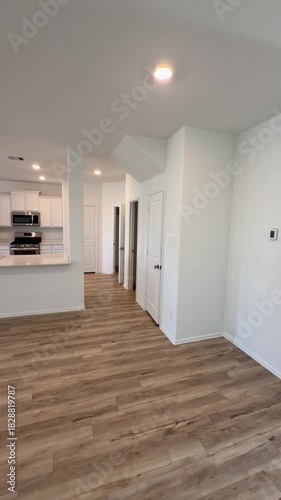Empty House Interior Open Concept Living Room and Kitchen with Wood Flooring.  